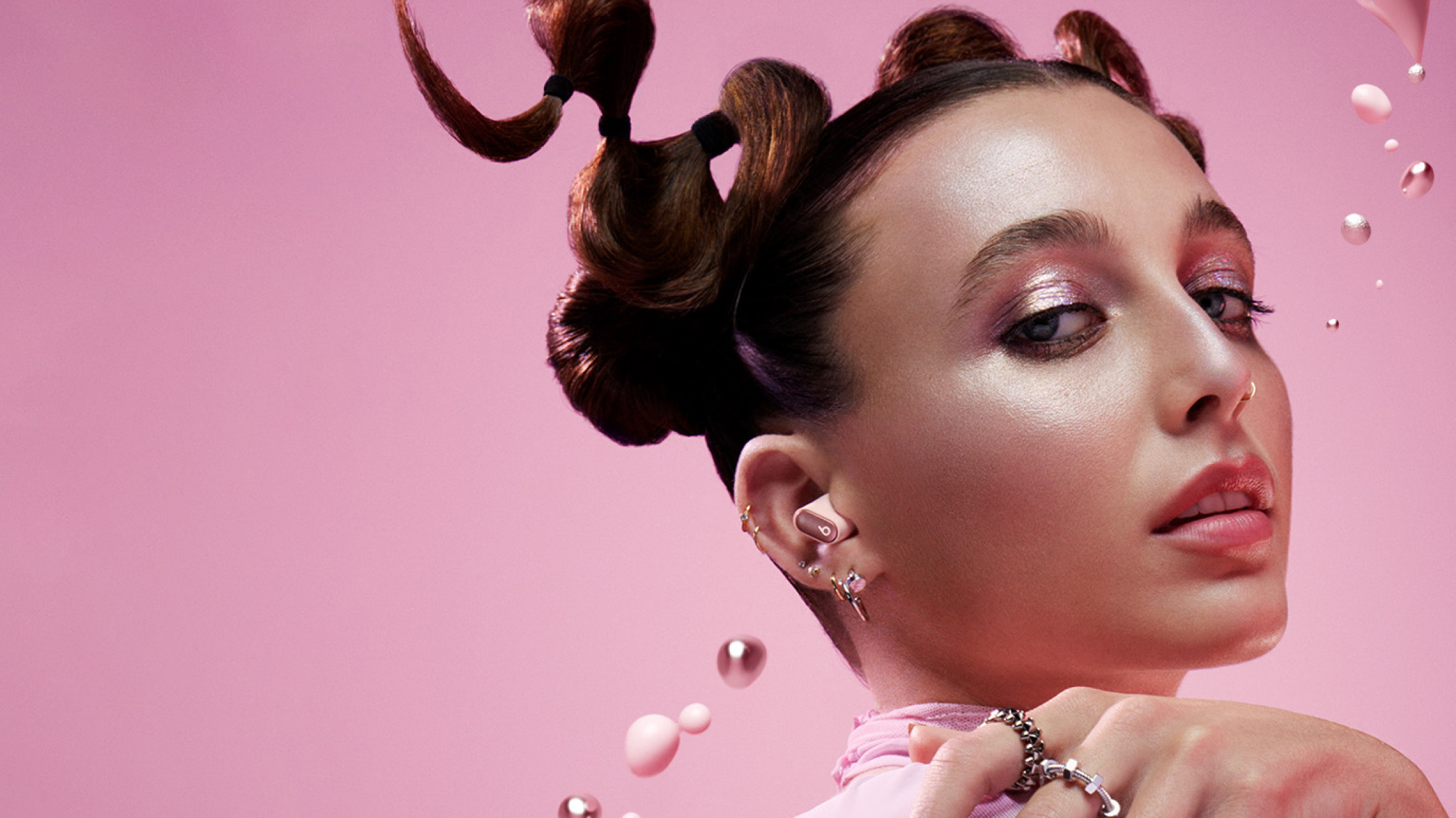 Emma Chamberlain wearing Cosmic Pink Beats Studio Buds Plus